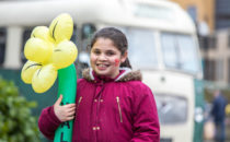 Photo of a girl holding a welsh daffodil at Croeso Swansea