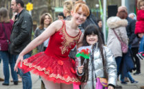 Photo of a dancer with a child from the crowd at Croeso Swansea
