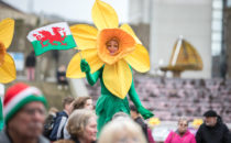 Photo of a performer in a welsh daffodil costume at Croeso Swansea